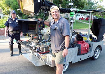 Ron with a Slider™ camera-movement system mounted on the rear of an electric Griptrix camera car for the Sarah Silverman Program