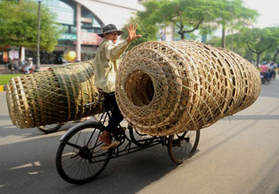 Photo of man and baskets in Saigon, South Vietnam by Ron Veto