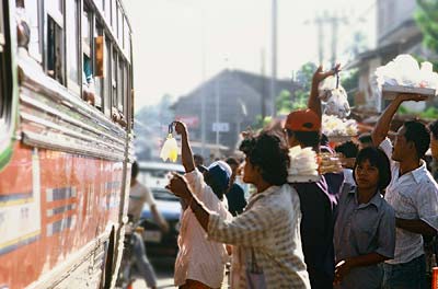 Photo of hawkers selling food outside of bus by Ron Veto