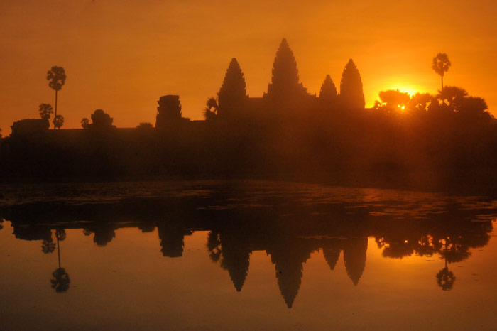 Silhouette photo of landscape reflected on water in Angkor Wat, Cambodia by Ron Veto /></div>

<p style=