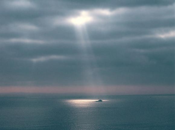 Photo of rays of light on a boat in the ocean off Maui, Hawaii by Ron Veto