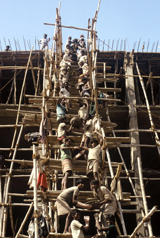 Photo of workers on scaffold in New Dehli, India by Ron Veto /></div>
<p style=